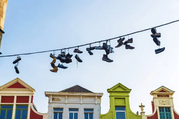 Sneakers and shoes hanging on a cable in Ghent, Belgium — Stock Photo, Image