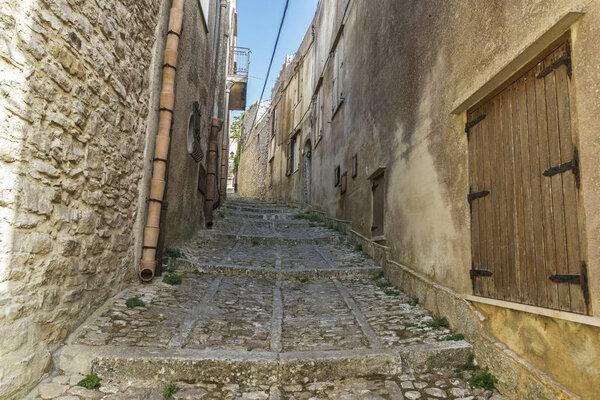 Street of the old town with steps of the historic village of Erice in Sicily, Italy