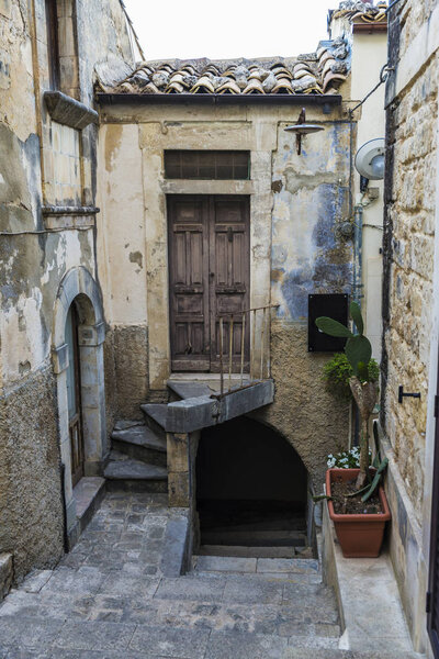 Street of the old town with steps of the historic village of Ragusa in Sicily, Italy