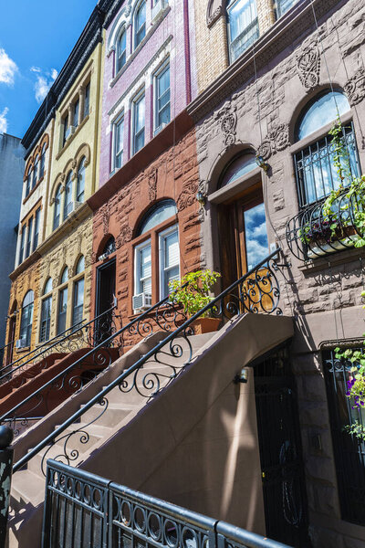 Old typical multicolor houses in the Harlem neighborhood in Manhattan, New York City, USA