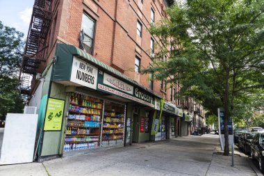 New York City, USA - August 4, 2018: Street with a grocery in Harlem, Manhattan, New York City, USA