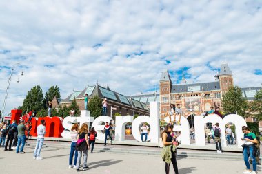 Amsterdam, Hollanda - 9 Eylül 2018: I Amsterdam 'ın Müze Meydanı ve Hollanda' daki Rijksmuseum (Ulusal Müze) çevresindeki insanlarla dolu büyük maddi işareti
