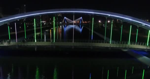 People Crossing Illuminated Bridge — Stock Video