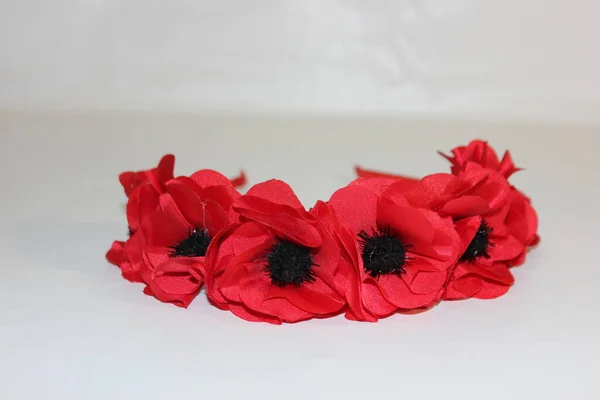 Bezel of red poppies on a white background. Red poppies from the fabric. Hairpin red. Hairpin with poppies.