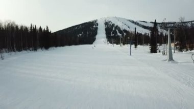 İnsanlar dağda kayak ve snowboardlarda kayıyor.