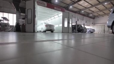 TOMSK, RUSSIA - June 28, 2019: White car is standing in a spray booth covered with a transparent film. Ready to paint