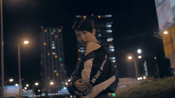 Korean girl posing at night on the street against the background of skyscrapers — 스톡 사진