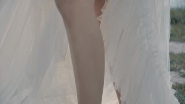 Blonde fille dans une robe blanche assis près du lac 