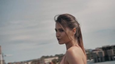 Spor kızı dans ediyor ve elinde bir telefon tutuyor.