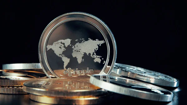 SIlver Ripple coin on black background. Silver Crypto coin on spinning stand.