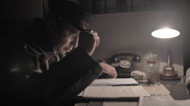 NKVD officer interrogates a prisoner, USSR time clipart