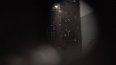 Dark prison corridor through a hole, old walls, scary
