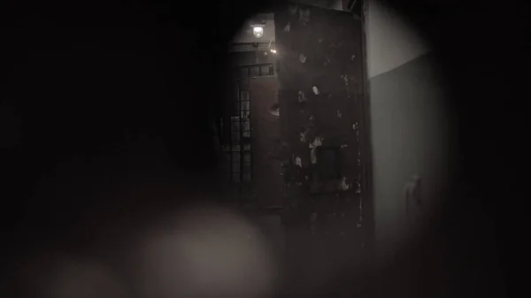 Dark prison corridor through a hole, old walls, scary