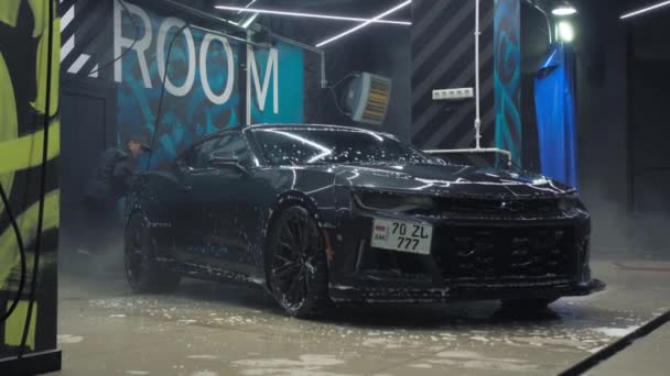 TOMSK, RUSSIA - March 30, 2020: Chevrolet Camaro ZL1 the Exorcist with high pressure washer — Stock Video