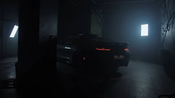 TOMSK, RUSSIA - March 30, 2020: Chevrolet Camaro ZL1 the Exorcist in the garage dark back view, taillights slow forward — 스톡 사진