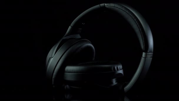 TOMSK, RUSIA - 12 de abril de 2020: Sony WH-1000XM3 Cancelación de ruido Auriculares inalámbricos en una plataforma de rotación de fondo negro — Vídeo de stock