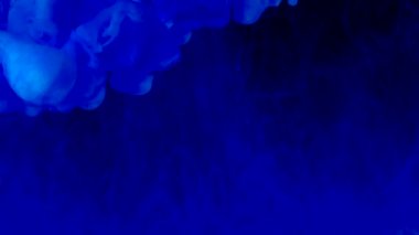 Amazing blue abstract background. Stylish modern background. Cool trending screensaver. Watercolor ink in water on a black background.