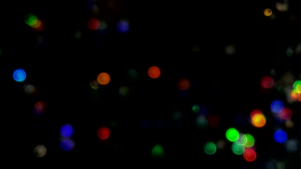 Fond abstrait vidéo au ralenti avec bokeh scintillant multicolore et brillant. Particules de paillettes de poussière de bokeh coloré paillettes. Particules volantes et scintillantes de lumière bokeh .