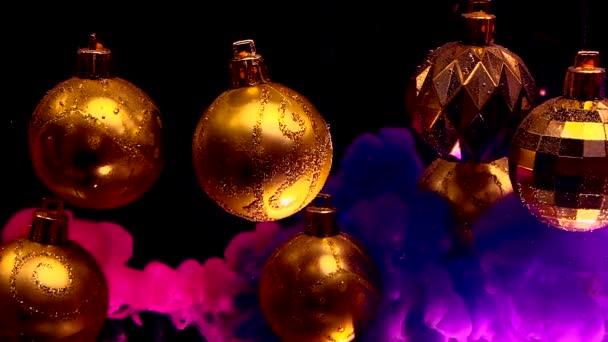 Golden Christmas Balls Black Background Pink Violet Ink Water Winter — Stock Video