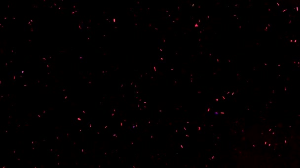 Fond abstrait vidéo au ralenti avec des étincelles brillantes rouges. Des particules de poussière colorée scintillent. Particules volantes et scintillantes de lumière .