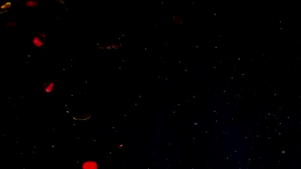 Rot und Gold flackernde Glitzerherzen auf schwarzem Sternenhintergrund. schöner romantischer Hintergrund.