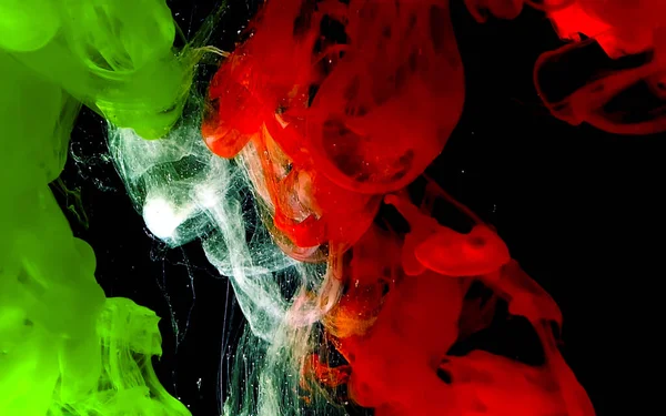 Green, white and red watercolor ink in water. — ストック写真