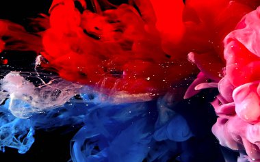 White, blue and red watercolor ink in water. Abstract background