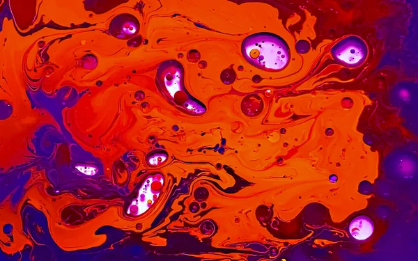 Orange and purple watercolor ink in water and oil. Amazing futuristic background. Planets, the universe and space. Abstract background. Cool trending screensaver.