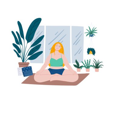 Woman is meditating on yoga mat at home. House plants near the window, urban jungle.