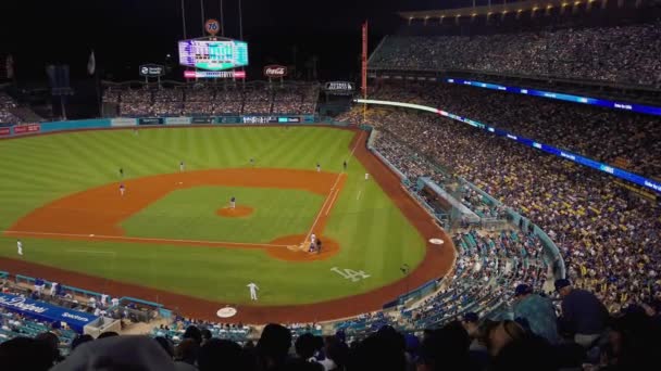 Dodgers baseball Stadium in Los Angeles California. Panning shot across stands with fans overlooking field — Stock Video