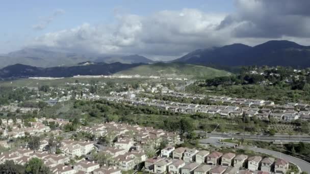 Los Angeles mountainside residential suburb, dark clouds over hills, aerial — Stock Video