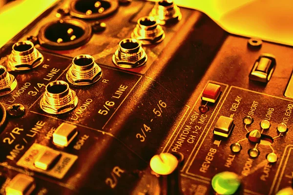 music console illuminated by the sun, shades of yellow, equipment, concert, sound