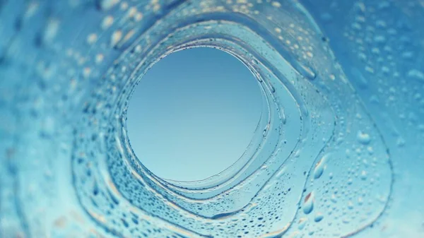 abstract photo with a view of the blue sky through a plastic bottle covered with water droplets