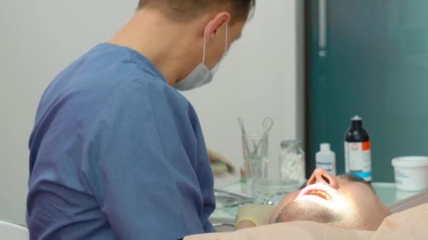 Patienten Tandläkarbesöket Tandläkare Medicinsk Klänning Behandlar Patient Vuxen Man — Stockvideo