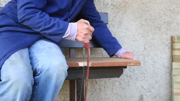 Hands Older Man Working Cutting Plank Wood Handsaw Ground Picnic — Stock Video