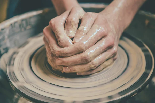 Master potter folded together hands sculpts a clay product — Stock Photo, Image