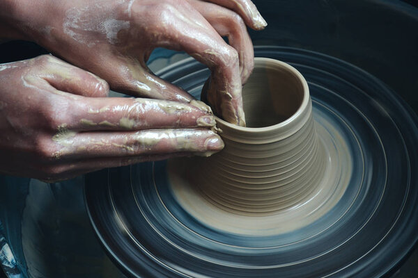 Creating vase of white clay close-up. Master crock.