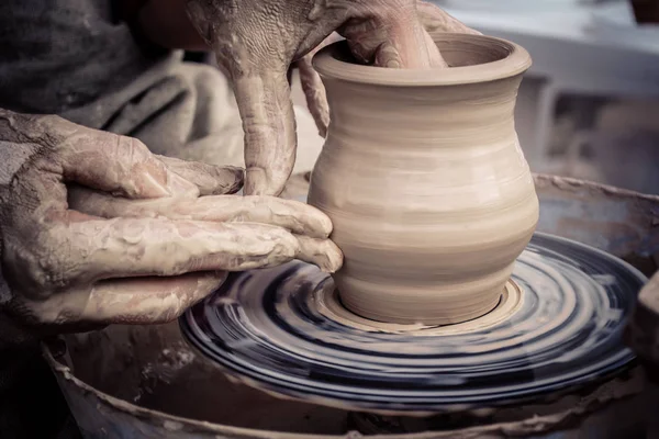 Master class on modeling of clay on a potter\'s wheel