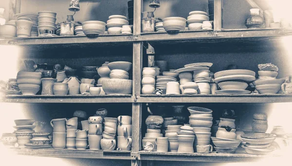 Old vintage photo.many different pottery standing on the shelves in a workshop — Stock Photo, Image
