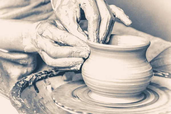 potter making vase from clay. Old vintage style.