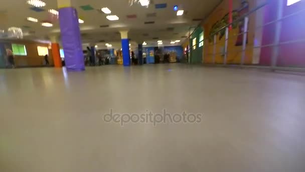 Een persoon die aan de binnenkant rolschaatsen rollerdrom. Oogpunt, pov mtb. Lage hoekmening. — Stockvideo
