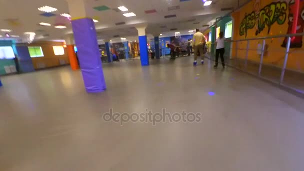 Slow motion. A Person roller-skating on the inside rollerdrom. Point of view, pov mtb. Low Angle View. — Stock Video