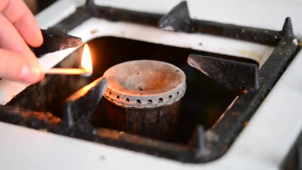 Woman ignites burner on the old gas stove wooden match — Stock Video