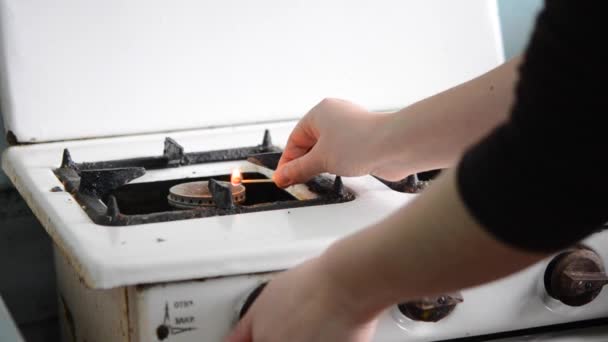 Woman ignites burner on the old gas stove wooden match — Stock Video