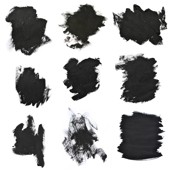 Conjunto de pinceladas negras sobre papel blanco —  Fotos de Stock