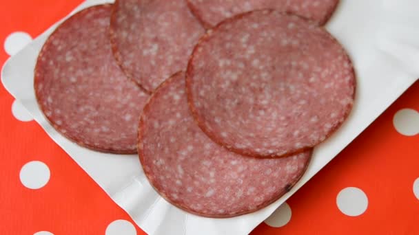 Person taking slices of smoked sausage. Close-up top view. — Stock Video