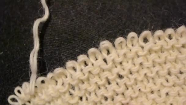 Unraveling the fabric knitted with woolen threads — Stock Video