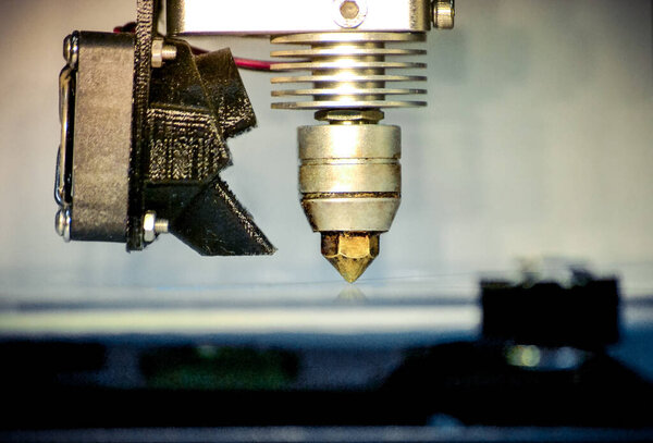 Modern 3D printer printing figure close-up