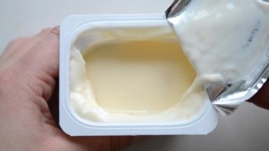 A man person opening yogurt