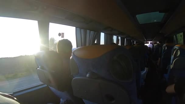Man looks out the window of riding bus. View from high speed bus — Stockvideo